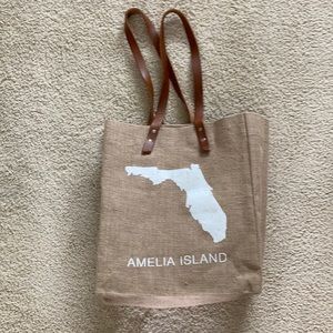 Jute bag with leather handles.